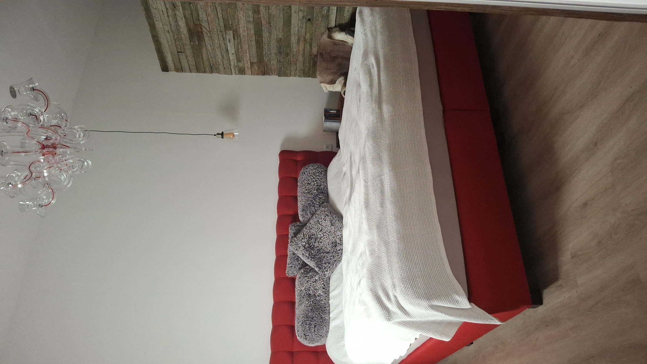 Doppelzimmer mit rotem Boxspringbett in der historischen Scheune